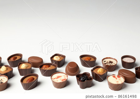 Flat lay composition with chocolate candies on white background 86161498