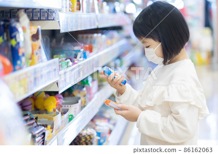 小學生戴著口罩在超市裡尋找自己想要的東西 86162063