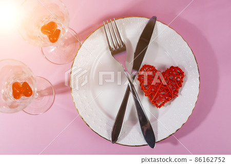 Valentine's day romantic dinner with red hearts on pink background. Valentine's day romantic dinner with red hearts on pink background. 86162752