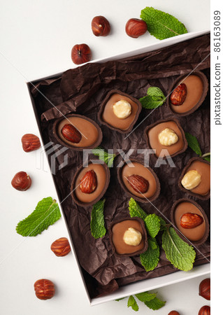 Concept of sweets with chocolate candies on white background 86163089