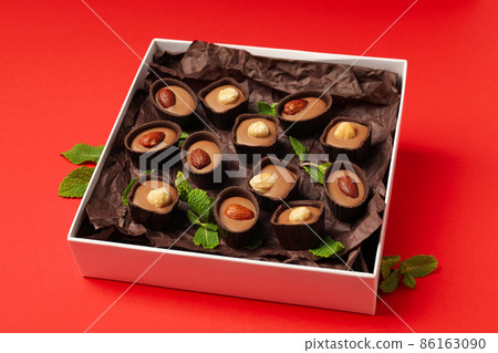 Concept of sweets with chocolate candies on red background 86163090