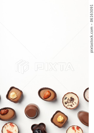Flat lay composition with chocolate candies on white background 86163091