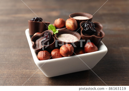 Concept of sweets with chocolate candies on wooden background 86163119