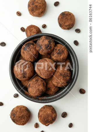 Concept of sweets with truffles on white background 86163744