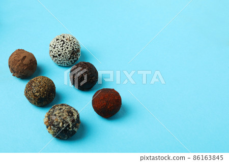 Flat lay composition with truffles on blue background Flat lay composition with truffles on blue background 86163845