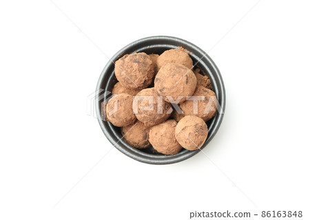Sweet truffles in bowl isolated on white background Sweet truffles in bowl isolated on white background 86163848