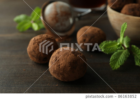 Concept of sweets with truffles on dark wooden background Concept of sweets with truffles on dark wooden background 86163852