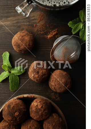 Concept of sweets with truffles on dark wooden background Concept of sweets with truffles on dark wooden background 86163853