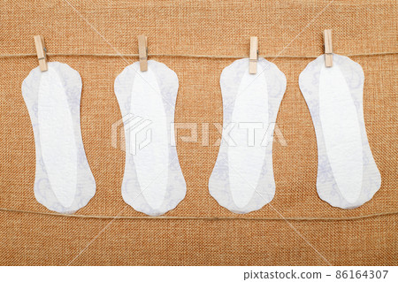 panty liners hanging on clothespins on a textile background. hygiene and women's health care concept 86164307