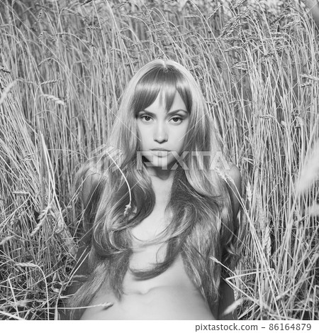 Nude beautiful woman is showing her naked body outside. Nude beautiful woman is showing her naked body outside. 86164879
