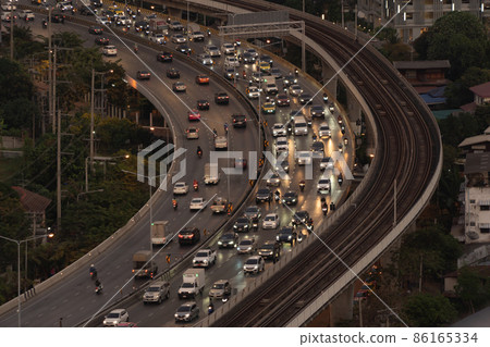 Aerial view of highway street road with cars traffic on railway, Bangkok Downtown. Thailand. Financial district in smart urban city. 86165334
