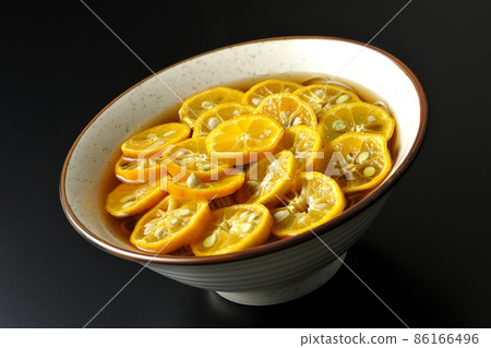 Photographed Sudachi soba with a lot of ripe sudachi slices on a black background Photographed Sudachi soba with a lot of ripe sudachi slices on a black background 86166496
