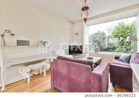 Charming living room with corduroy purple sofa and mosaic chandelier Charming living room with corduroy purple sofa and mosaic chandelier 86166523