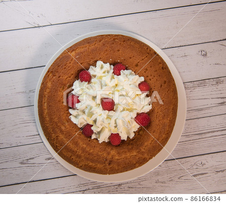 Pastry, Traditional Italian rum cake with whipped cream and raspberries 86166834