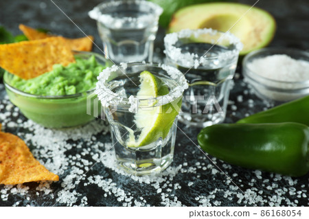 Party concept with tequila, guacamole and chips Party concept with tequila, guacamole and chips 86168054