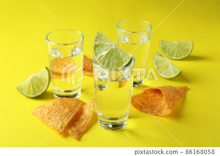 Party concept with tequila, guacamole and chips Party concept with tequila, guacamole and chips 86168058