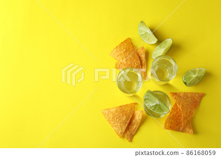 Party concept with tequila, guacamole and chips Party concept with tequila, guacamole and chips 86168059