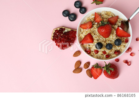 Concept of tasty eating with oatmeal on pink background Concept of tasty eating with oatmeal on pink background 86168105