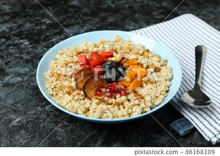 Concept of tasty eating with oatmeal on black smokey background 86168109