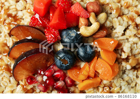 Fresh cooked oatmeal with fruits, close up 86168110