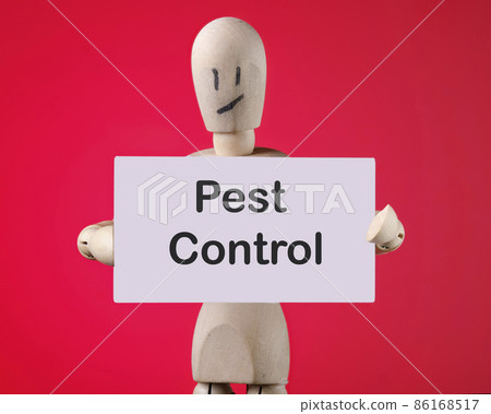 A wooden man holds a card with phrase PEST CONTROL 86168517