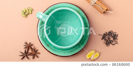 Empty green teacup and spices ingredients for making healthy Indian tea drink masala chai 86168600