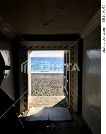 Blue sea after passing through a dark tunnel Blue sea after passing through a dark tunnel 86169142