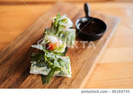 Spring rolls with shrimp, wooden chopsticks and soy sauce. Asian cuisine. 86169745