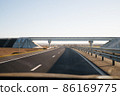 View of empty open road from car window. 86169775