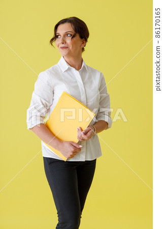 Beautiful woman office worker holding document folder Beautiful woman office worker holding document folder 86170165
