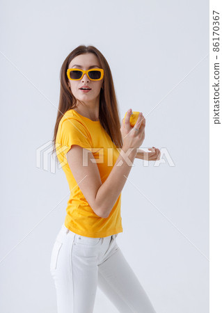 Charming woman in stylish sunglasses holding perfume Charming woman in stylish sunglasses holding perfume 86170367