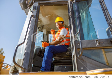 Manual worker driving cargo truck in plant Manual worker driving cargo truck in plant 86170393