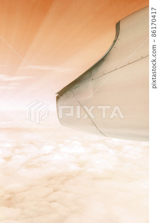 A wonderful view from the window of an airplane: red-orange and light like the setting sun A wonderful view from the window of an airplane: red-orange and light like the setting sun 86170417