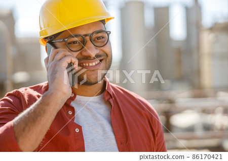 Smiling young industrial engineer working in plant 86170421