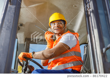 Worker in safety equipment working at heavy industry plant 86170422