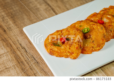 Korean food kimchi jeon on a white plate Korean food kimchi jeon on a white plate 86173183