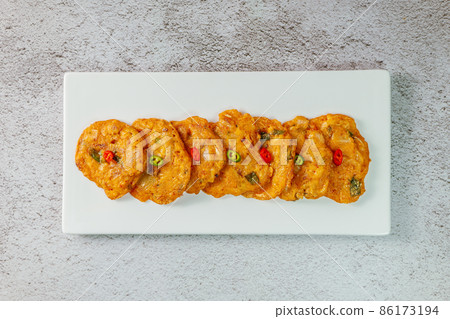 Korean food kimchi jeon on a white plate Korean food kimchi jeon on a white plate 86173194