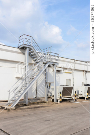 Steel railing roof stairs. Metal staircase to the roof of a modern building. Steel railing roof stairs. Metal staircase to the roof of a modern building. 86174063