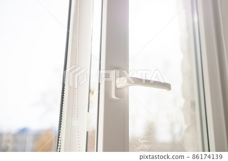 White plastic pvc window with forest background at home. Sunbeam through glass 86174139