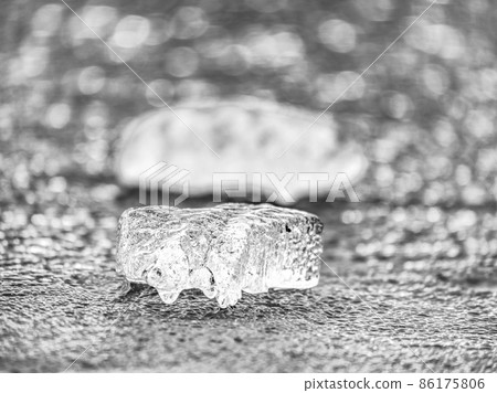 Ice shard and small cracked ice pieces on melring glacier. Icy fragments are melting 86175806