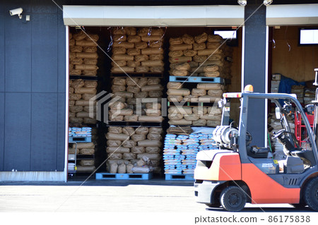 Rice bags stacked high in a warehouse Rice bags stacked high in a warehouse 86175838