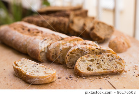 fresh loaf of bread on wooden board 86176508