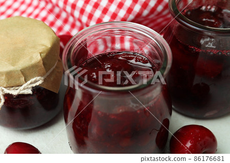Glass jar with cherry jam, close up 86176681
