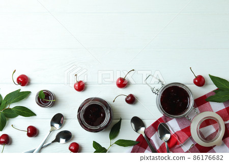 Cherry jam and ingredients on white wooden table Cherry jam and ingredients on white wooden table 86176682
