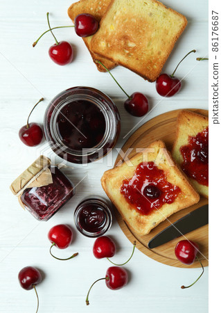 Cherry jam and ingredients on white wooden table Cherry jam and ingredients on white wooden table 86176687