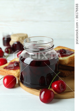 Cherry jam and ingredients on white wooden table 86176688