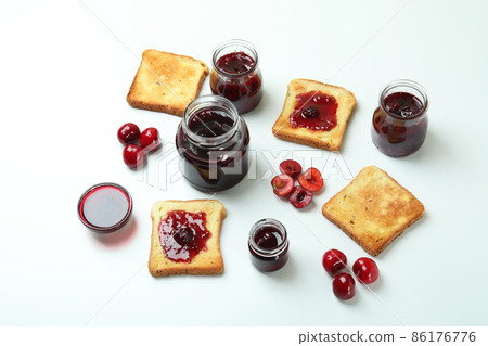 Cherry jam sandwiches and ingredients on white background 86176776