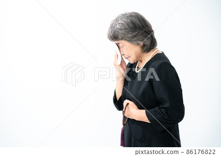 Senior female funeral gassho prayer 86176822