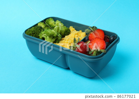 Lunch box with tasty food on blue background 86177021