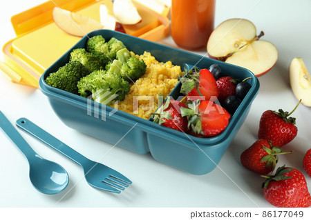 Lunch box with tasty food on white background Lunch box with tasty food on white background 86177049